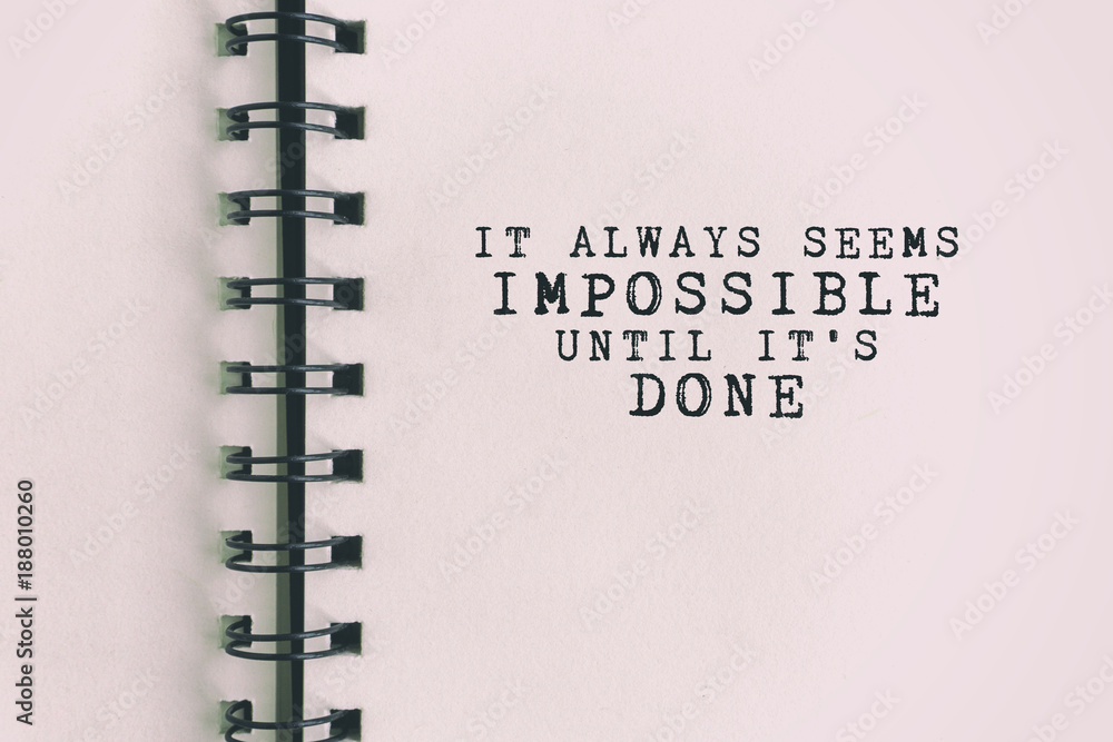 Fototapete inspirational quote - it always seems impossible until it's done. blurry retro background.