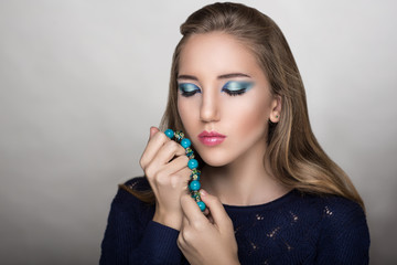 Woman holds beads