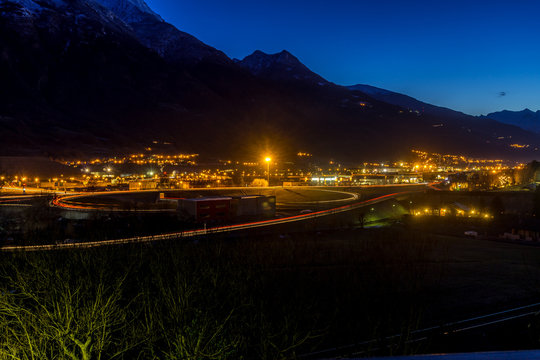 Italian city at blue hour with mountains on background