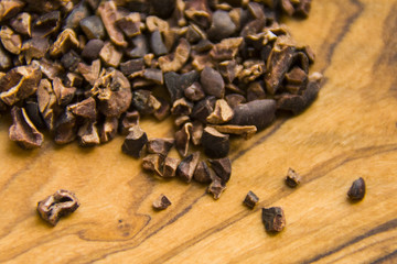 cocoa nibs over the wooden background