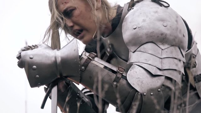 Jeanne D Arc bends over the sword and cries