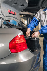Engine engineer is replacing car battery because car battery is depleted. concept car maintenance