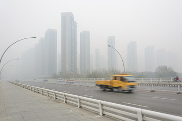 Fototapeta premium City in a heavy hazy weather. The deterioration of air quality resulted in low horizontal visibility. Located in Sanhao Bridge, Shenyang, Liaoning, China.