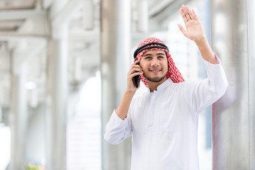 Arab business use mobile phone to connect to customer.