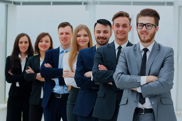 Business team in a line smiling at the camera.