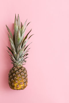 Top view on fresh organic pineapple on light oink background. Fruit.