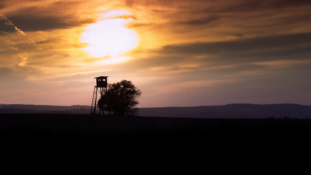 Hunting tower on horizon during the sunset, 16:9 aspect ratio