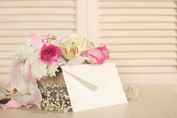 Fototapeta na wymiar Basket of flowers and envelope
