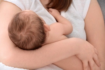 Fototapeta na wymiar Mother holding sleeping newborn baby, closeup