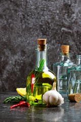 Obraz na płótnie Canvas Olive Oil With Herbs and Spices on the dark background