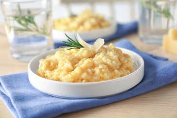 Plate with delicious risotto on wooden table