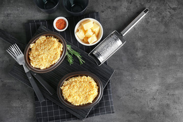 Bowls with delicious risotto on wooden board