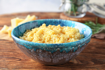 Dish with delicious risotto on wooden table