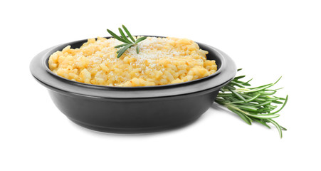 Bowl with delicious risotto on white background
