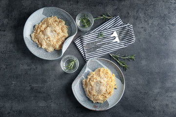 Plates with delicious risotto on table