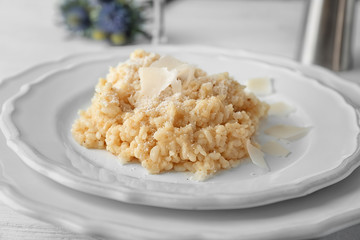 Plate with delicious risotto on table, closeup