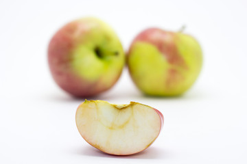 Naklejka na ściany i meble Apple slice on the background of two apples