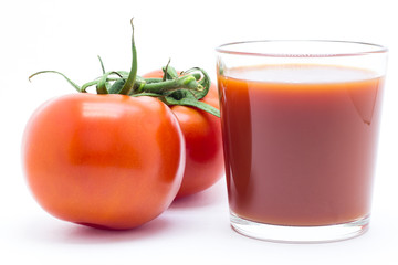 Glass with tomato juice and fresh tomatoes on white background