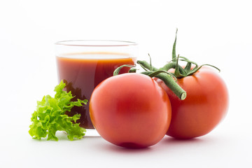 Glass with tomato juice and fresh tomatoes on white background