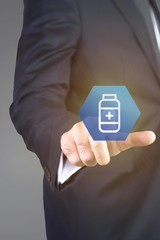 Close up of businessman touching medical icon with finger 