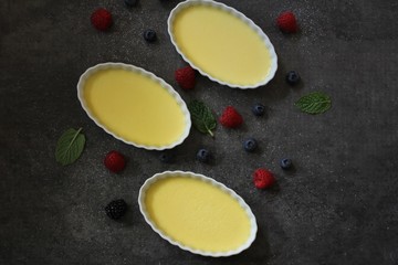 Homemade Creme Brulee with berries overhead view