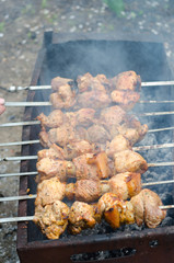 Process of grilling meat on open fire