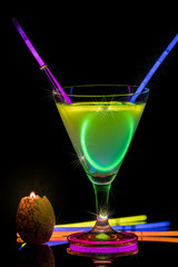 Cocktail with neon lights and candlelight