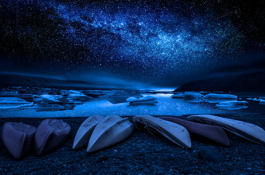 Milky way, kayaks and the glacier lake at night, Iceland