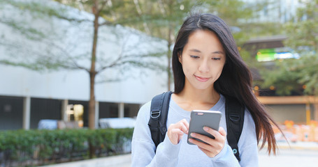 Woman look at mobile phone at outdoor