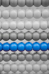 Closeup of abacus with only the blue beads in color