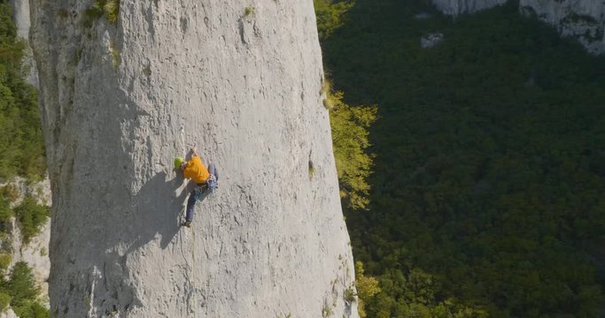 Aerial of amazing solo climber in nature ona  summer day.
