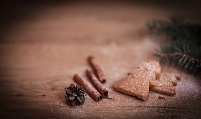 cinnamon sticks, cookies and Christmas tree branch but the tabl