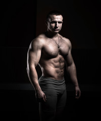 Fototapeta na wymiar Portrait of a bodybuilder on a black background