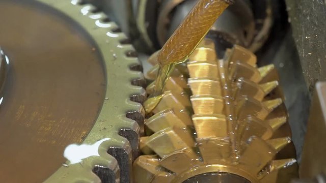 The close up of trenching the alluminium circle by the special machine on the plant. The rows or metal cutters are turning from up to dowm and making the striations on the surface of the detail which
