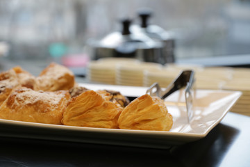 cookies on a plate background the window and kettles, blur effect