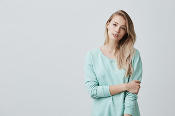 Cheerful european girl with parted lips, rejoicing her life, dressed casually standing isolated...