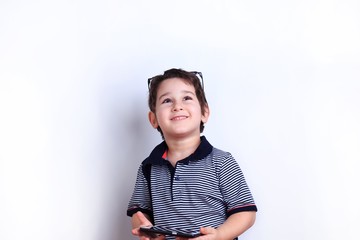 Dreamy boy with smartphone in hands. Technology, mobile apps, children and parental advisory, lifestyle concept.