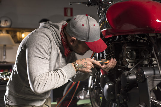 Motorbike mechanic repairing a motorbike