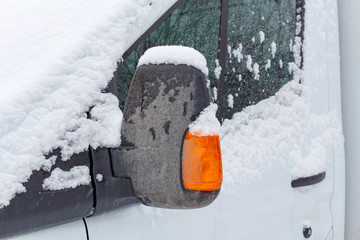 Fragment of the snow covered cab of the truck