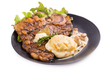 T-Bone Beef Steak In black plate.  Beef Steak Dinner. isolated on white background