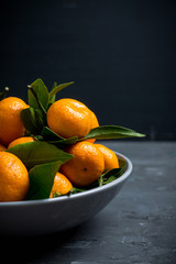 Mandarines on the rustic wooden background. Selective focus. Shallow depth of field.