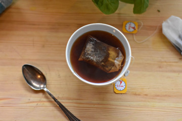 Top view of cup of the read healthy tea on light wooden table