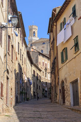 Fototapeta na wymiar Walking up to the Town Hall Palazzo dei Priori - Volterra, Tuscany, Italy