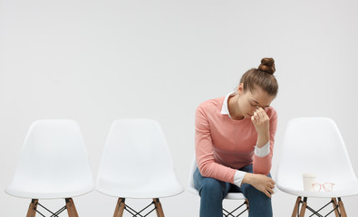 Young female student failed exam, sitting in the line afrter failure. Education, school test concept