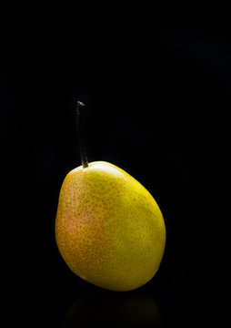 Pear isolated on black background. Selective focus. Shallow depth of field.