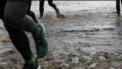 Runners In Water and Mud In Obstacle Endurance Race Slow Motion - Powered by Adobe