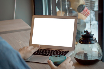 Young businessman with coffee and white laptop