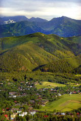 Fototapeta na wymiar Poland, Tatra Mountains – Panoramic view of Zakopane town with Kasprowy Wierch, Skrajna Turnia and Swinica peaks in the background