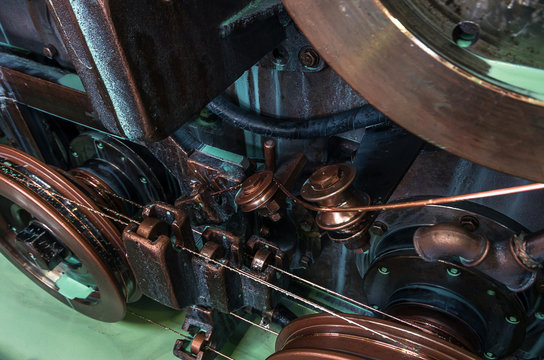 Copper round rollers for rolling wire. Fragment Wire drawing equipment. Abstract industrial background.