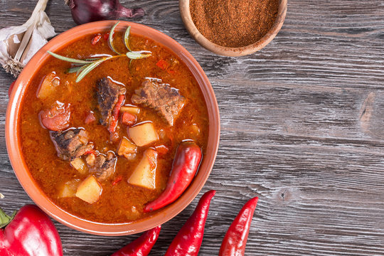 Goulash on rustic wooden  background. Traditional hungarian meal,  beef stew. Copy space